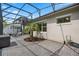 Relaxing screened-in patio featuring brick pavers and a cozy seating area at 14072 Alafaya Oak Bnd, Orlando, FL 32828