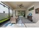Screened-in patio with dining set, ceiling fan, and convenient access to the backyard at 14072 Alafaya Oak Bnd, Orlando, FL 32828