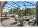 Expansive screened patio with comfortable seating, a dining area, and well-maintained landscaping, perfect for relaxing outdoors at 14072 Alafaya Oak Bnd, Orlando, FL 32828