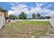 Expansive backyard with lush green grass, white vinyl fence, and covered patio, perfect for outdoor activities at 150 Tarpon Cir, Winter Springs, FL 32708
