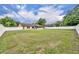 Expansive backyard features a white privacy fence, a well-maintained lawn, and the home's screened-in porch at 150 Tarpon Cir, Winter Springs, FL 32708