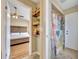 Hall view to a bedroom with a bathroom including shelving, walk-in shower with tile, and colorful curtains at 150 Tarpon Cir, Winter Springs, FL 32708