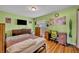 This is a furnished bedroom with a bed, an American flag, an entertainment center, and a desk with a map at 150 Tarpon Cir, Winter Springs, FL 32708