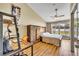 Comfortable bedroom with a built-in wardrobe bed and desk, complemented by natural light from the backyard view at 150 Tarpon Cir, Winter Springs, FL 32708