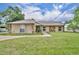 Charming home featuring stone accents, a well-manicured lawn, and welcoming walkway at 150 Tarpon Cir, Winter Springs, FL 32708