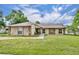 Charming home featuring stone accents, a well-manicured lawn, and welcoming walkway at 150 Tarpon Cir, Winter Springs, FL 32708