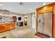 Kitchen with stone countertops, tile flooring, and stainless-steel refrigerator at 150 Tarpon Cir, Winter Springs, FL 32708