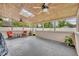 This is an unfurnished screened porch with a ceiling fan, skylight, and a partial view of the fenced yard at 150 Tarpon Cir, Winter Springs, FL 32708