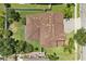 Aerial view of a home with a tile roof and a lush green lawn and beautiful landscaping at 1501 Prairie Oaks Dr, St Cloud, FL 34771