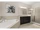 Bright bathroom featuring a walk-in shower with glass doors, a soaking tub and granite counters at 1501 Prairie Oaks Dr, St Cloud, FL 34771