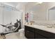 Bright bathroom featuring horse-themed decor, a vanity with granite countertop, and neutral tones at 1501 Prairie Oaks Dr, St Cloud, FL 34771