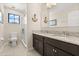 Well-lit bathroom featuring a double sink vanity, a glass-enclosed shower, and neutral color palette at 1501 Prairie Oaks Dr, St Cloud, FL 34771