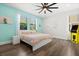 Bright bedroom with ample natural light, featuring a large window, ceiling fan, and stylish decor at 1501 Prairie Oaks Dr, St Cloud, FL 34771