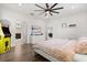 Spacious bedroom featuring hardwood floors, ceiling fan, and fun Pac-Personal themed decor at 1501 Prairie Oaks Dr, St Cloud, FL 34771