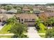 Exterior elevation of a two-story home with manicured landscaping and a paver driveway at 1501 Prairie Oaks Dr, St Cloud, FL 34771