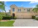 Stunning two-story home featuring a tile roof, three-car garage, and beautifully paved driveway at 1501 Prairie Oaks Dr, St Cloud, FL 34771