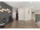 Bright hallway featuring hardwood floors, neutral walls, and a minimalist design aesthetic with geometric wall decor at 1501 Prairie Oaks Dr, St Cloud, FL 34771