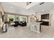 Open-concept living room and kitchen, with a large sofa, bar seating, and backyard views at 1501 Prairie Oaks Dr, St Cloud, FL 34771