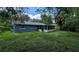 Well-maintained backyard featuring a screened-in porch, perfect for enjoying the outdoors, and a spacious lawn at 1507 Sw 4Th St, Ocala, FL 34471