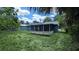 Large backyard showcasing a screened-in porch, providing a comfortable outdoor living space and ample green space at 1507 Sw 4Th St, Ocala, FL 34471
