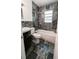 Modern bathroom features stone tile, a shower/tub combination, and updated fixtures at 1507 Sw 4Th St, Ocala, FL 34471