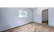 Bright bedroom with a window and a view to the yard and an open doorway to another room at 1507 Sw 4Th St, Ocala, FL 34471