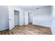 Bright bedroom featuring wood-look flooring, neutral walls, open closet and passageway door at 1507 Sw 4Th St, Ocala, FL 34471
