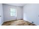Bedroom features a wooden floor and a window view of greenery at 1507 Sw 4Th St, Ocala, FL 34471