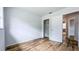 A well-lit bedroom featuring a wooden floor, white walls and an open closet at 1507 Sw 4Th St, Ocala, FL 34471