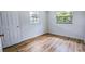 Bright bedroom with natural light, wood-look flooring, and neutral walls at 1507 Sw 4Th St, Ocala, FL 34471