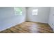 Bedroom with wood-look flooring and plenty of natural light from two windows at 1507 Sw 4Th St, Ocala, FL 34471