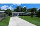 Charming single-story home with a well-manicured lawn, garden, and long driveway at 1507 Sw 4Th St, Ocala, FL 34471