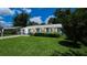 Charming single-story home with a lush green lawn and beautifully trimmed hedges at 1507 Sw 4Th St, Ocala, FL 34471