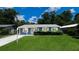 Charming single-story home featuring a lush green lawn, neat landscaping, and a freshly painted exterior at 1507 Sw 4Th St, Ocala, FL 34471