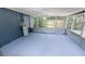Enclosed screened patio showcasing painted concrete floor and the water heater at 1507 Sw 4Th St, Ocala, FL 34471
