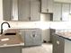 Unfinished kitchen featuring modern gray cabinets, black hardware, and light countertops at 15083 Grove Lake Dr, Winter Garden, FL 34787