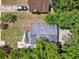 This aerial view shows the roof of a house, a driveway with car, grass and mature trees at 1906 S Summerlin Ave, Sanford, FL 32771