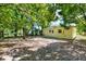 View of the home's backyard featuring a patio, trees, and partial fencing, providing ample space for outdoor activities at 1906 S Summerlin Ave, Sanford, FL 32771