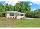 Neat home with green lawn, featuring refreshed landscaping, and a clean walkway at 1906 S Summerlin Ave, Sanford, FL 32771