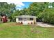 Charming home featuring a well-maintained lawn and manicured garden beds at 1906 S Summerlin Ave, Sanford, FL 32771