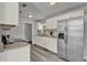 Bright kitchen with white cabinets, granite countertops, and stainless-steel refrigerator at 1906 S Summerlin Ave, Sanford, FL 32771