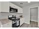 Well-lit kitchen showcasing modern appliances and granite countertops at 1906 S Summerlin Ave, Sanford, FL 32771