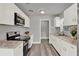 The kitchen features updated white cabinets, a gas oven, and granite countertops at 1906 S Summerlin Ave, Sanford, FL 32771