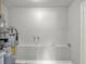 Laundry room in a house with painted white walls, and modern water heater at 1906 S Summerlin Ave, Sanford, FL 32771