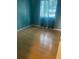 Cozy bedroom with wood floors and a bright window at 1921 Stone Abbey Blvd, Orlando, FL 32828