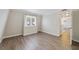 Cozy bedroom with hardwood floors, a large window, and view into the kitchen at 1948 Conway Rd # 8, Orlando, FL 32812