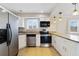 Modern kitchen with stainless steel appliances, granite countertops, and white cabinets at 1948 Conway Rd # 8, Orlando, FL 32812