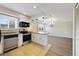 Stylish kitchen with stainless steel appliances, breakfast bar, and an adjacent dining area at 1948 Conway Rd # 8, Orlando, FL 32812