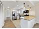 Bright kitchen features stainless appliances, granite counters, white cabinets and a breakfast bar at 1948 Conway Rd # 8, Orlando, FL 32812