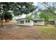 Wide angle of backyard featuring an open patio, garden bed, and fire pit at 1957 Deloy Dr, Daytona Beach, FL 32119